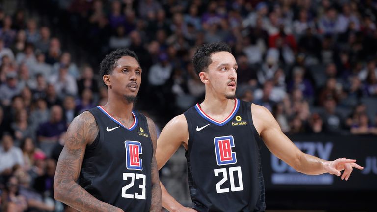 Lou Williams shares a word with rookie team-mate Landry Shamet