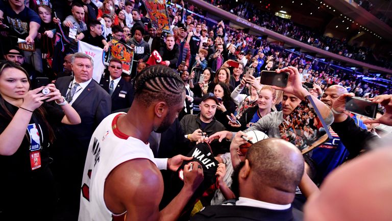 Dwyane Wade signs autographs for fans after the game against the New York Knicks