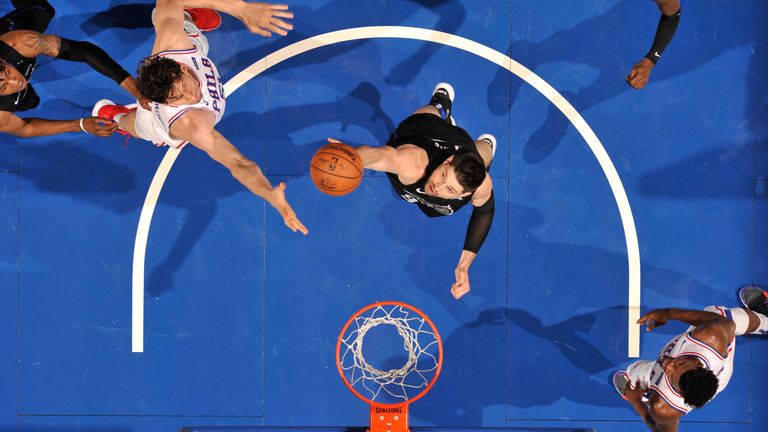 Nikola Vucevic pulls down a rebound against Philadelphia