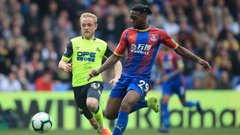 Alex Pritchard puts pressure on Aaron Wan-Bissaka during the Premier League match between Crystal Palace and Huddersfield Town at Selhurst Park on March 30, 2019