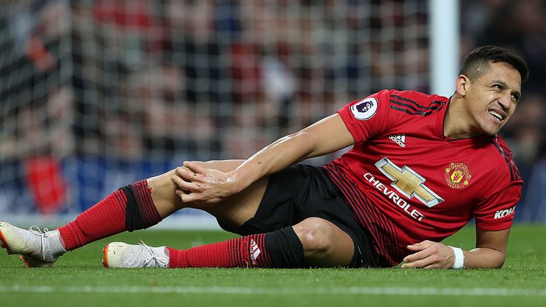 Alexis Sanchez lies injured on the pitch at Old Trafford during the Premier League match against Southampton 