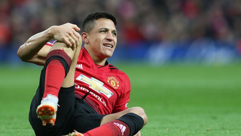 Alexis Sanchez lies injured on the pitch at Old Trafford during the Premier League match against Southampton 