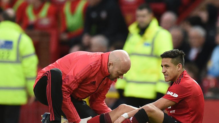 Alexis Sanchez receives medical attention after picking up an injury during the Premier League match against Southampton 