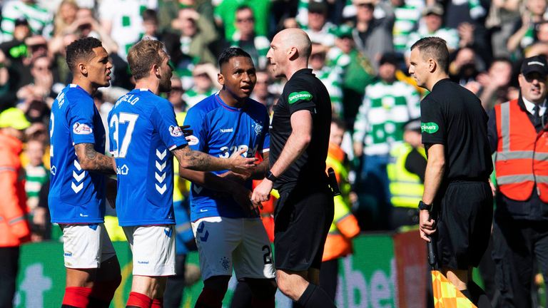 .Alfredo Morelos pleads his innocence after being shown a red card by referee, Bobby Madden