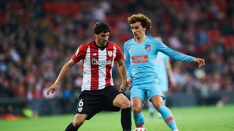 Antoine Griezmann of Atletico Madrid duels for the ball with Mikel San Jose of Athletic Club