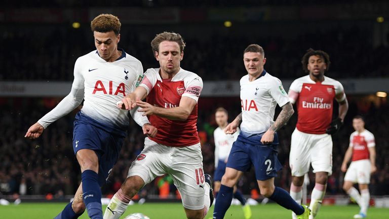 Dele Alli and Nacho Monreal compete for the ball in the North London derby