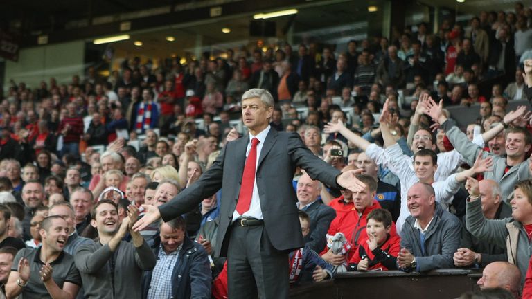 Arsene Wenger protests from the stands at Old Trafford
