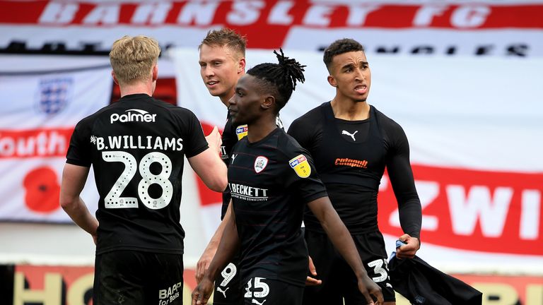 Barnsley's Jacob Brown (right) celebrates with his team-mates after he scores his sides first goal