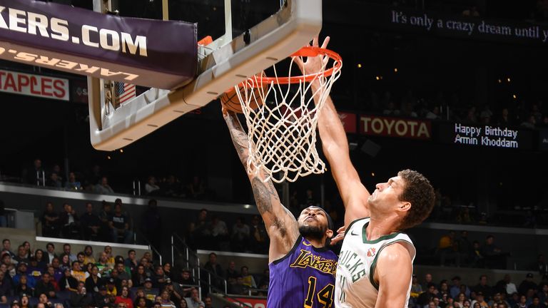 Brandon Ingram of the Los Angeles Lakers dunks the ball against Brook Lopez of the Milwaukee Bucks