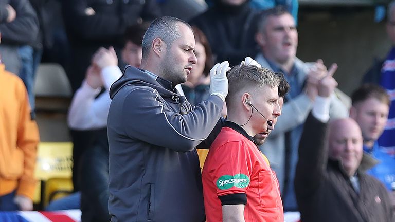 Assistant referee Calum Spence needed treatment after being struck by an object during a game