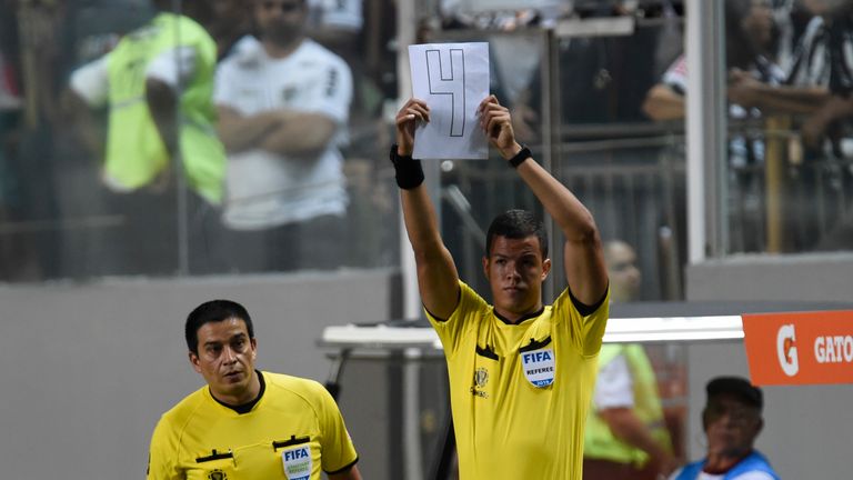 The fourth official indicates a minimum of four minutes added time