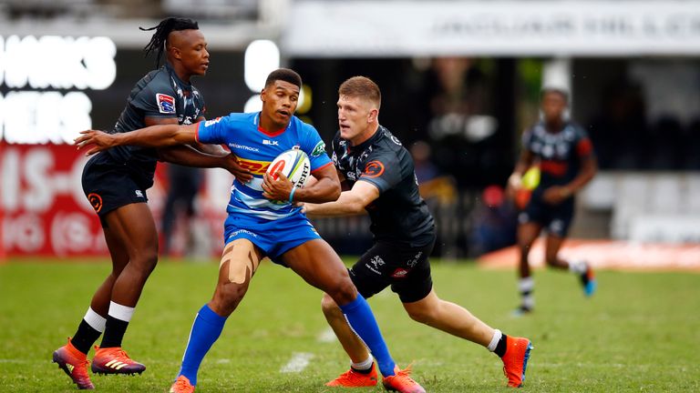 Damian Willemse of the DHL Stormers tackled by Sbusiso Nkosi and Jacques Vermeulen of the Sharks