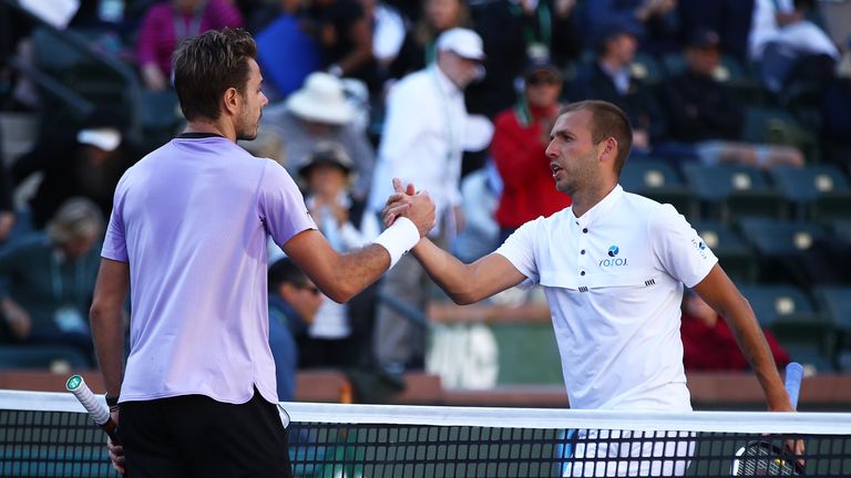 Dan Evans of Great Britain shakes hands at the net after his three set defeat against Stan Wawrinka of Switzerland during their men's singles first round match on day five of the BNP Paribas Open at the Indian Wells Tennis Garden on March 08, 2019 in Indian Wells, California. 