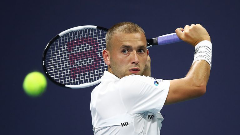 Dan Evans of Great Britain returns the ball against Malek Jaziri of Tunisia during day four of the Miami Open tennis on March 21, 2019 in Miami Gardens, Florida.