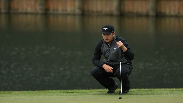 Eddie Pepperell lines up a putt at the 18th during the final round of The Players Championship
