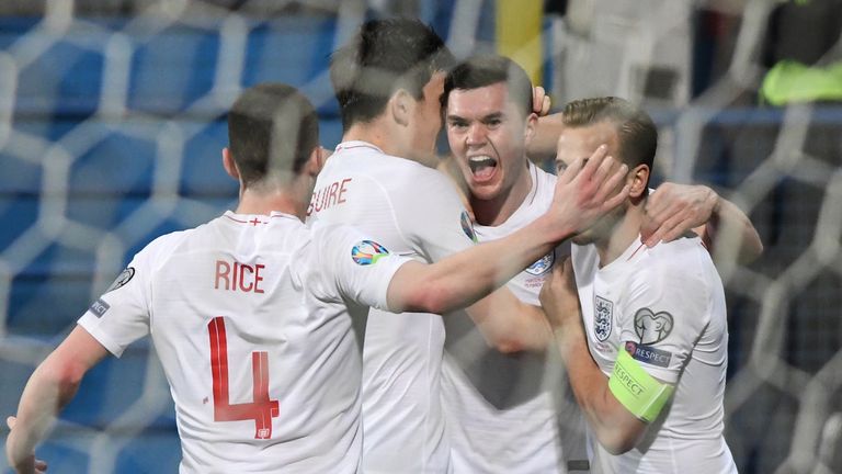 England defender Michael Keane (C-R) is congratulated by teammates after scoring during the European Qualifier between Montenegro and England in Podgorica