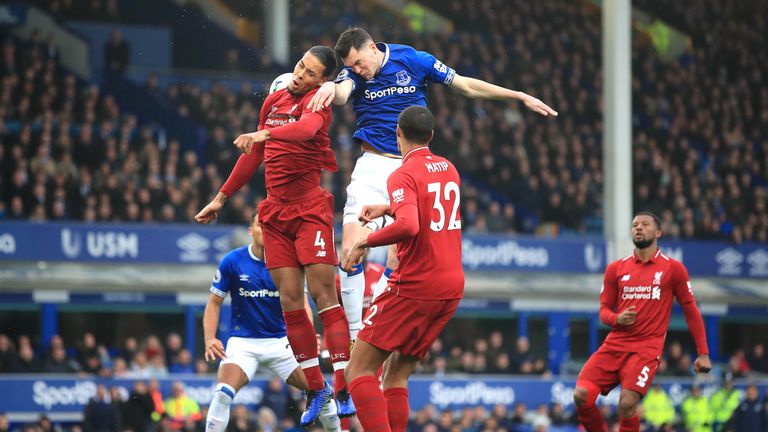 Liverpool's Virgil van Dijk (left) battles for the ball with Everton during the Premier League match at Goodison Park, Liverpool.
