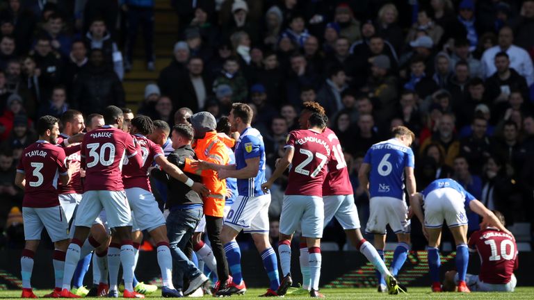 A fan attacks Aston Villa's Jack Grealish on the pitch (right) during the Sky Bet Championship match at St Andrew's Trillion Trophy Stadium, Birmingham. PRESS ASSOCIATION Photo. Picture date: Sunday March 10, 2019. See PA story SOCCER Birmingham. Photo credit should read: Nick Potts/PA Wire. RESTRICTIONS: EDITORIAL USE ONLY No use with unauthorised audio, video, data, fixture lists, club/league logos or "live" services. Online in-match use limited to 120 images, no video emulation. No use in betting, games or single club/league/player publications.