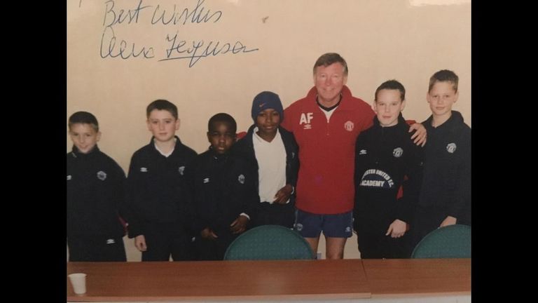 Febian Brandy (second from left) received a signed photograph from Sir Alex Ferguson
