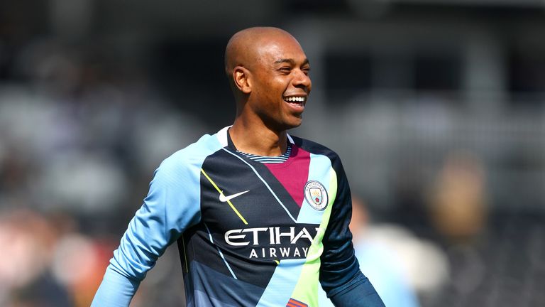 Fernandinho warms up in a Manchester City mash-up jersey ahead of the match against Fulham at Craven Cottage