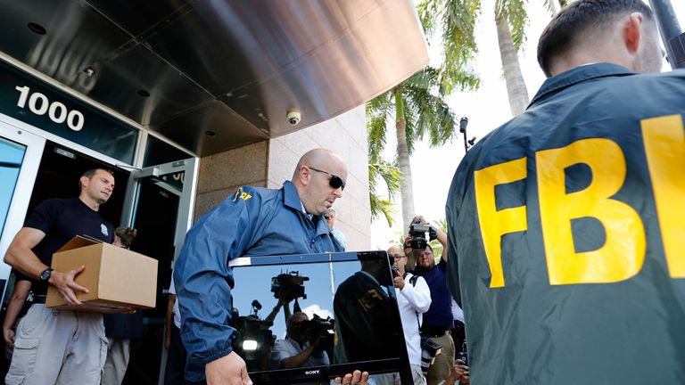 FBI agents carry boxes and computers from the headquarters of CONCACAF after it was raided in Miami Beach, Florida in 2015