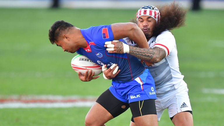 Alamanda Motuga of Samoa (L) is tackled by Folau Niua