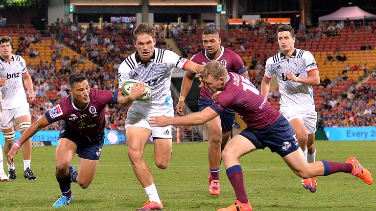 George Bridge of the Crusaders takes on the Reds defence