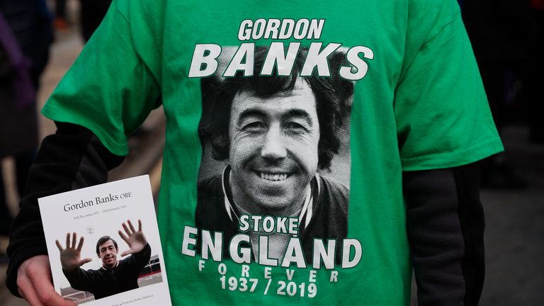 A Stoke City fan with an order of service for former Stoke City and England goalkeeper Gordon Banks at the bet365 Stadium