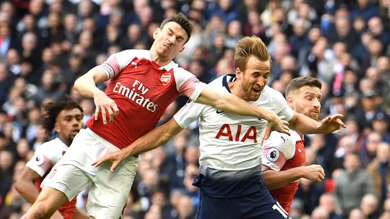 Harry Kane of Tottenham Hotspur is fouled by Shkodran Mustafi of Arsenal resulting in a penalty during the Premier League match between Tottenham Hotspur and Arsenal FC at Wembley Stadium on March 02, 2019 in London, United Kingdom.