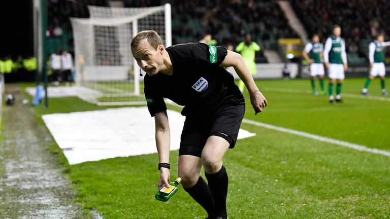 02/03/19 WILLIAM HILL SCOTTISH CUP QUARTER - FINALS.HIBERNIAN v CELTIC.EASTER ROAD - EDINBURGH.Referee Wiillie Collum removes a bottle from the pitch, which was thrown from the stands