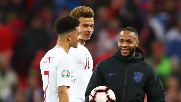 Raheem Sterling talks to Jadon Sancho and Dele Alli after his hat-trick on Friday night