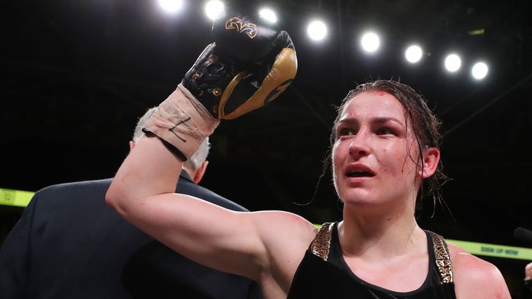 Katie Taylor celebrates after adding the WBO lightweight title to her WBA and IBF belts