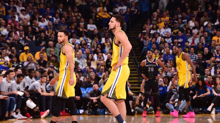 Klay Thompson #11 and Stephen Curry #30 of the Golden State Warriors look on during a game against the Detroit Pistons on March 24, 2019 at ORACLE Arena in Oakland, California.