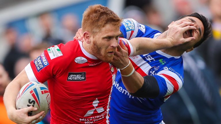  Salford's Kris Welham fends off Wakefield's Justin Horo.