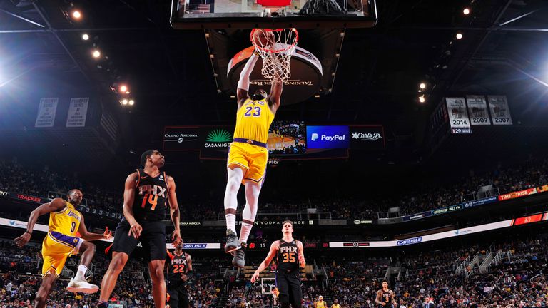 LeBron James #23 of the Los Angeles Lakers dunks the ball during the game against De'Anthony Melton #14 of the Phoenix Suns on March 2, 2019 at Talking Stick Resort Arena in Phoenix, Arizona.