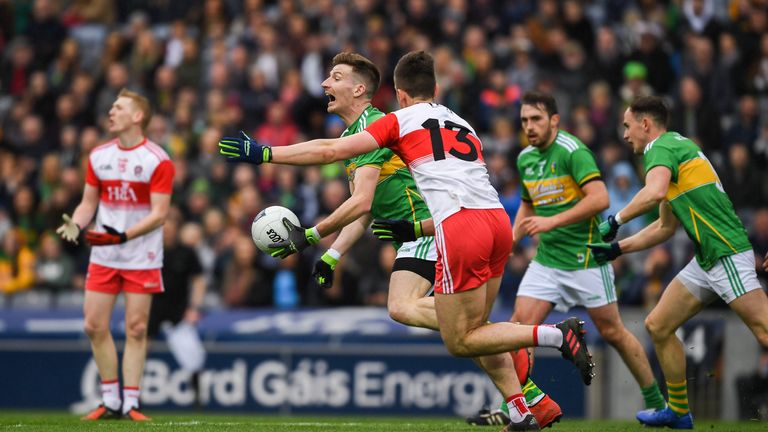 Shane Quinn of Leitrim in action against Shane McGuigan of Derry