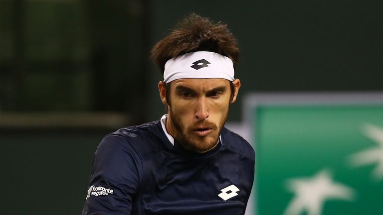 Leonardo Mayer of Argentina plays a backhand against Reilly Opelka of the United States during their men's singles first round match on day four of the BNP Paribas Open at the Indian Wells Tennis Garden on March 07, 2019 in Indian Wells, California.