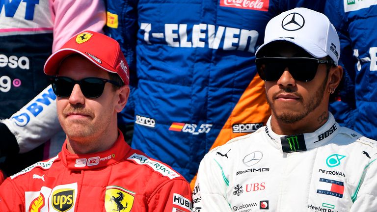 Mercedes' British driver Lewis Hamilton (R) sits with Ferrari's German driver Sebastian Vettel (L) during the driver's photo in Melbourne on March 17, 2019, ahead of the Formula One Australian Grand Prix. 