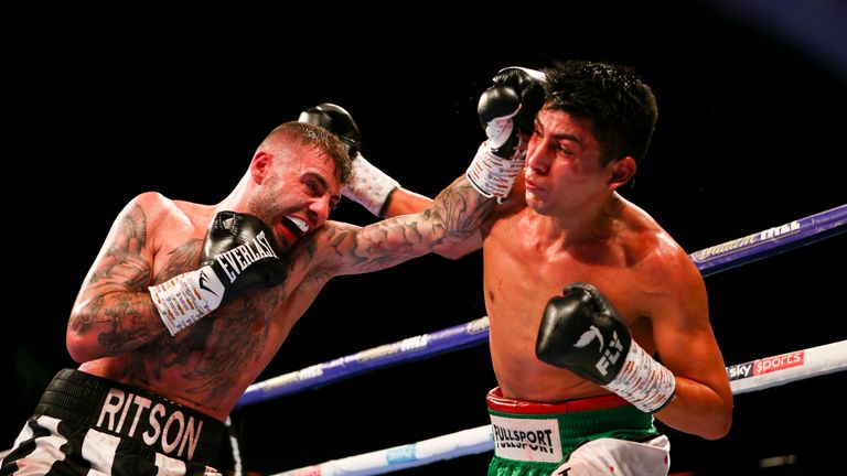 Lewis Ritson lands a left hand as German Benitez counters with a right during their super lightweight clash.