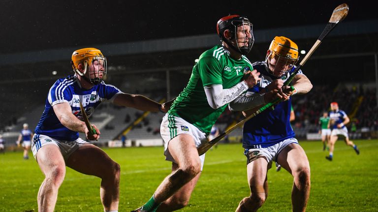 David Dempsey of Limerick in action against Padraig Delaney, left, and Mark Kavanagh of Laois