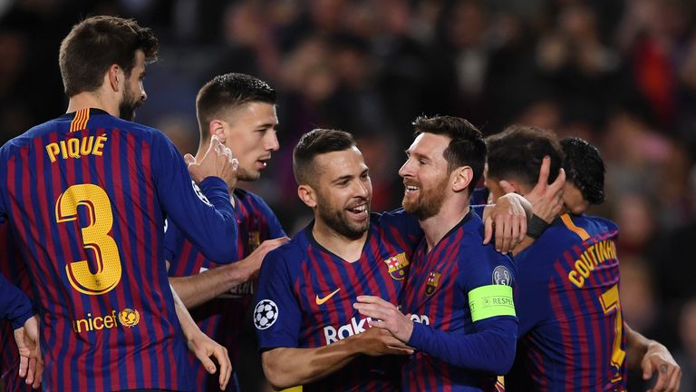 Lionel Messi celebrates scoring Barcelona's first goal from a penalty with Jordi Alba and team-mates