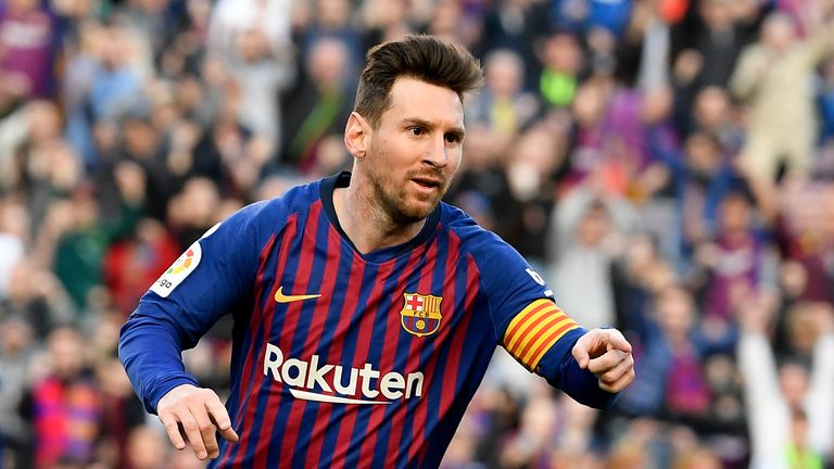 Lionel Messi celebrates scoring one of his two goals against Espanyol 