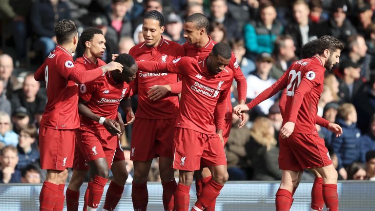 Sadio Mane of Liverpool celebrates with his team after he scores his sides first goal during the Premier League match between Fulham FC and Liverpool FC at Craven Cottage on March 17, 2019 in London, United Kingdom. (