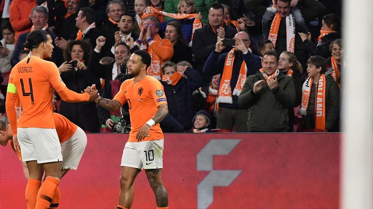 Netherlands' forward Memphis Depay (R) celebrates with Netherlands' defender Virgil Van Dijk after scoring the equalizer during the UEFA Euro 2020 Group C qualification football match between The Netherlands and Germany at the Johan Cruyff Arena in Amsterdam on March 24, 2019