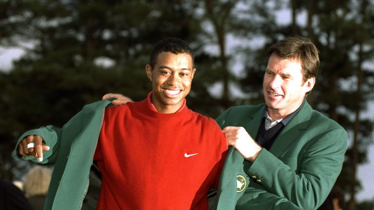 Nick Faldo helps Tiger Woods into his first Green Jacket in 1997