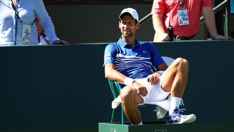 Novak Djokovic sits in a line judges chair during an exhibition doubles match with partner Pete Sampras (out of picture) against Tommy Haas and John McEnroe on day thirteen of the BNP Paribas Open at the Indian Wells Tennis Garden on March 16, 2019 in Indian Wells, California