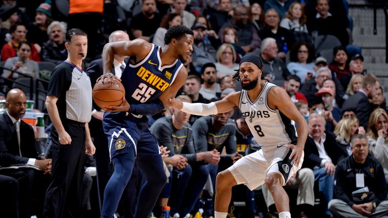 SAN ANTONIO, TX - MARCH 4: Malik Beasley #25 of the Denver Nuggets handles the ball while Patty Mills #8 of the San Antonio Spurs plays defense during the game on March 4, 2019 at the AT&T Center in San Antonio, Texas. NOTE TO USER: User expressly acknowledges and agrees that, by downloading and or using this photograph, user is consenting to the terms and conditions of the Getty Images License Agreement. Mandatory Copyright Notice: Copyright 2019 NBAE (Photos by Mark Sobhani/NBAE via Getty Images)