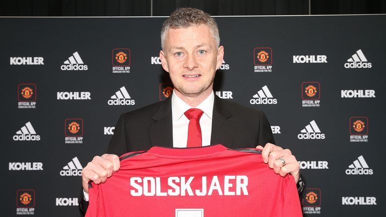 Ole Gunnar Solskjaer poses for a photo during a press conference after being announced as full-time manager of Manchester United