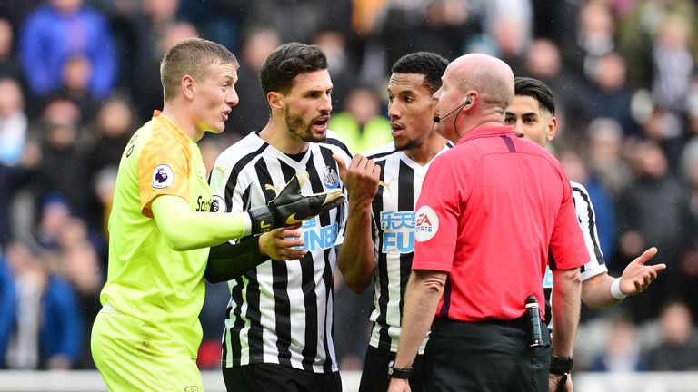 Referee Lee Mason awards a penalty against Jordan Pickford during Newcastle's match with Everton.