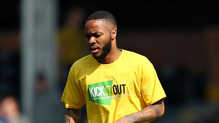 Raheem Sterling warms up for Manchester City wearing a 'Kick It Out' t-shirt